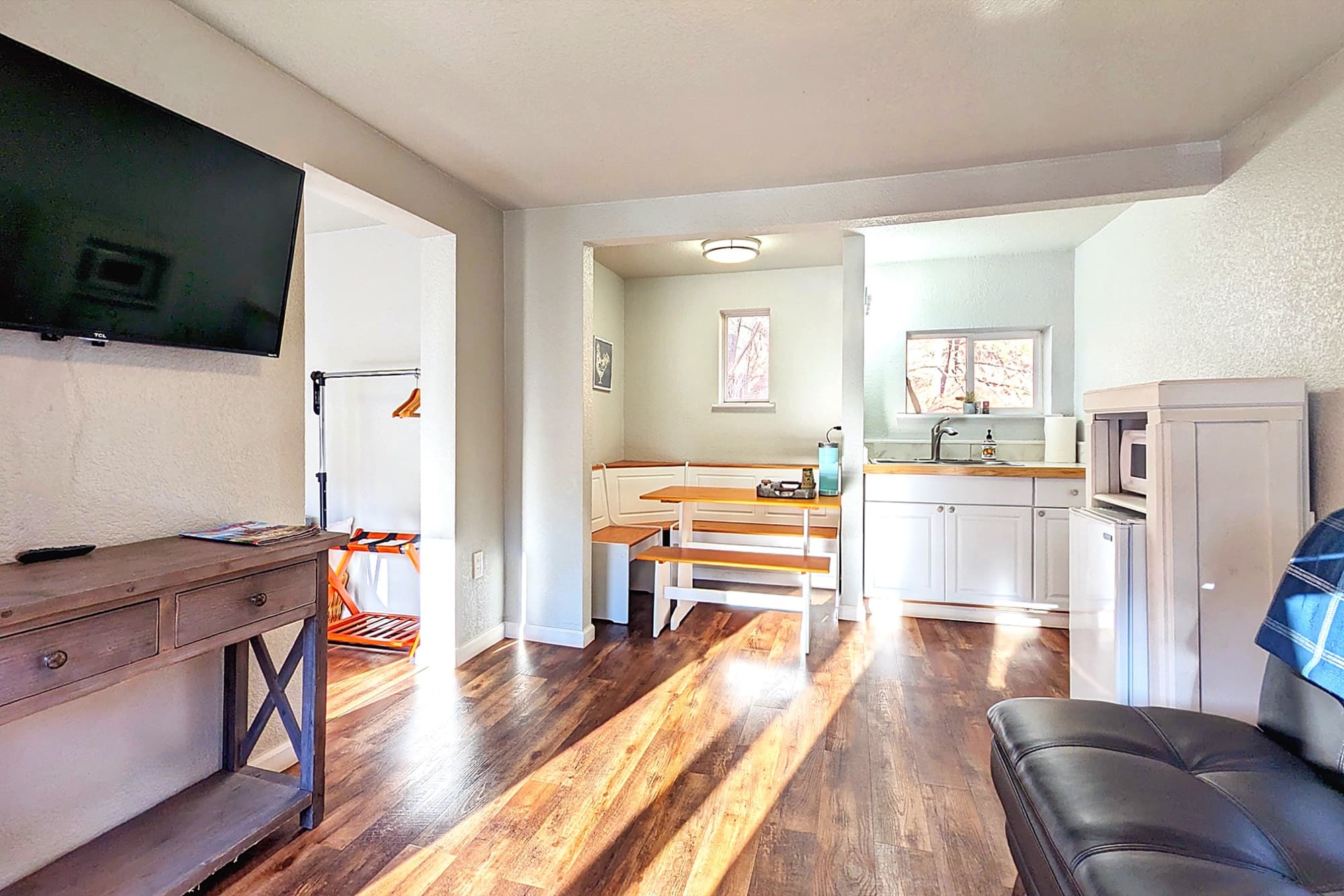 Inside a room at the Fountain Creek Inn, warm light and the quiet end of Manitou Avenue beyond